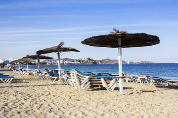 Chairs and umbrellas on a beautiful sandy beach at Ibiza