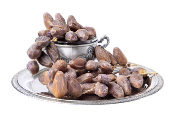 Fresh fruit dates in a silver metal bowl on a  isolated  white background