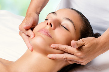 Beauty facial massage on female chin.