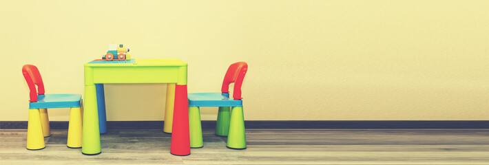 Interior, Children's Room, Children's multi-colored table near the beige wall