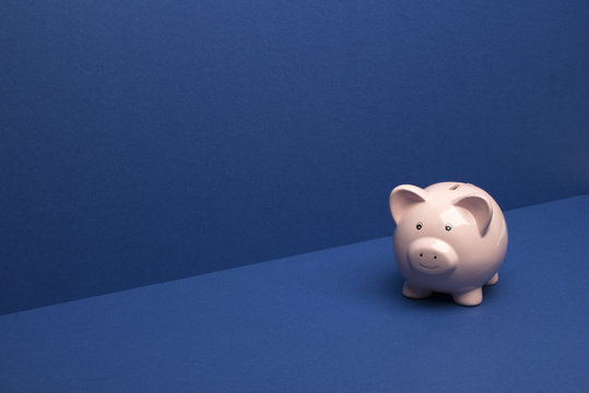 Piggybank on Blue Wall/Floor Background with Copy Space