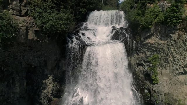 Spectacular Waterfall Aerial Flying Down Canyon Cliff with Water Splashing in Slow Motion