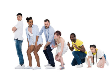 Fototapeta premium group of young multiethnic people gesturing and posing together isolated on white