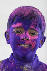 Boy covered with holi colours 