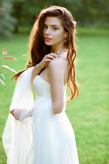 Brunette bride in fashion white wedding dress with makeup