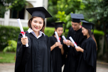 Young Asian Woman Students wearing Graduation hat and gown at University, Woman with Graduation Concept.