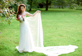 Fototapeta na wymiar Brunette bride in fashion white wedding dress with makeup