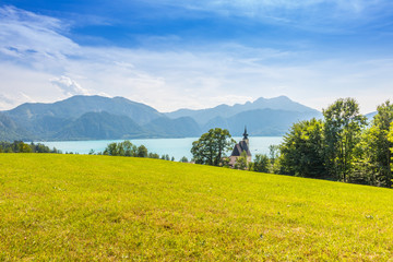 Fototapeta na wymiar romantic church Sankt Andreas with beautiful view to the lake Attersee in Austria