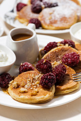 sweet corn pancakes with berries for breakfast, vertical closeup