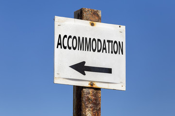 Accommodation word and arrow signpost