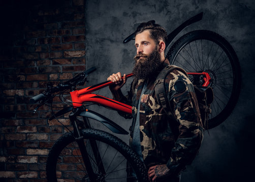 A man holds mountain bicycle.