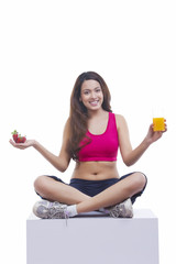 Portrait of woman holding juice and strawberry