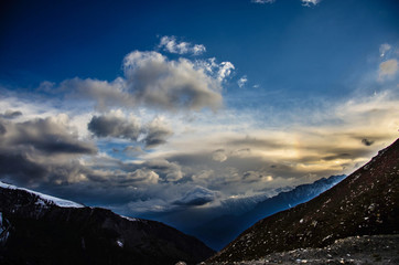 blue sky with cloudy texture and soft sun rays and mountains 