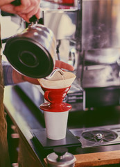 Close up image of a man preparing coffee late.
