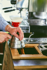 Close up image of a man preparing coffee late.