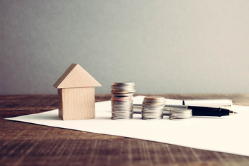 save money for investment mortgage concept by money house from a coins with filter effect retro...