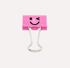 Obraz premium Cute smile pink binder clip isolated on white background with clipping path