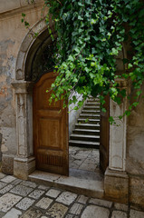 Fototapeta na wymiar Porec, Old gate with dooor and steps, Croatia