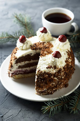 Chocolate and whipped cream cake with cherries