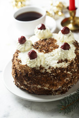 Chocolate and whipped cream cake with cherries