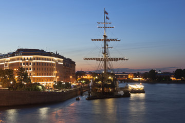 View of the Flying Dutchman sailboat on Mytninskaya Embankment in a summer night in St. Petersburg,...
