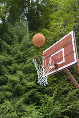 Basketball heading to the net on a outside sports arena. Concept for sport