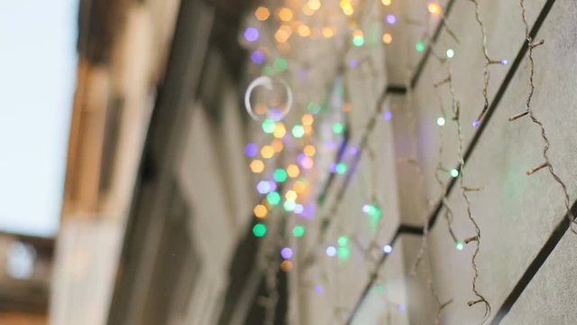 Beatiful colorful garland decorated wall of some city bilding. Close up.