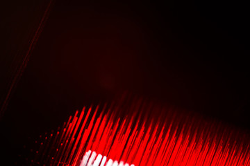 Black abstract blurred background with red stripes