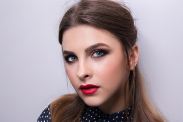 Fototapeta premium Fashionable portrait of a girl model with red lips.