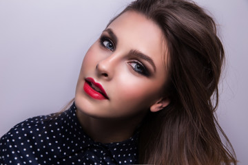 Fashionable portrait of a girl model with red lips.