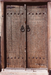 Wooden door with antique ornamentation