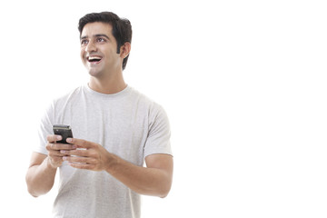 Cheerful young man holding cell phone on white background 