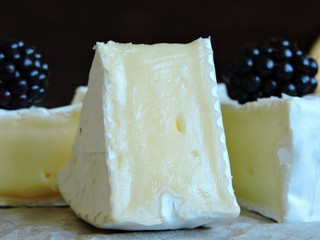 Gourmet Camembert cheese with berries. Macro.