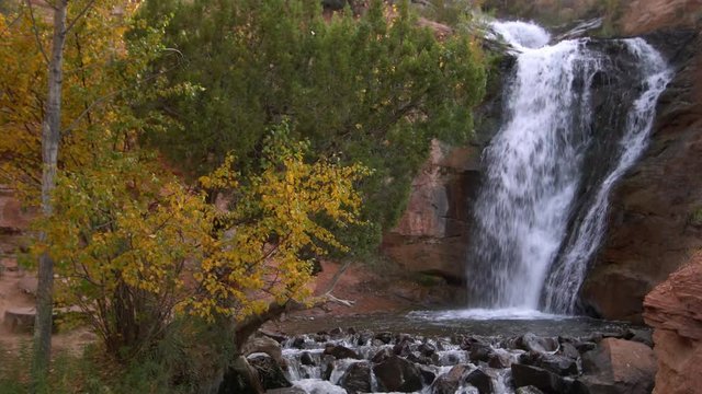 Small waterfall flowing through desert landscape during Autumn at Faux Falls Moab, UT.