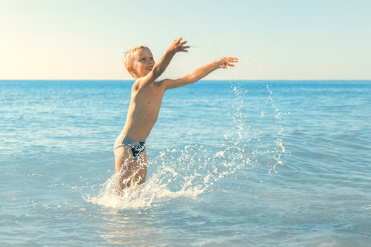 a boy plays in the sea