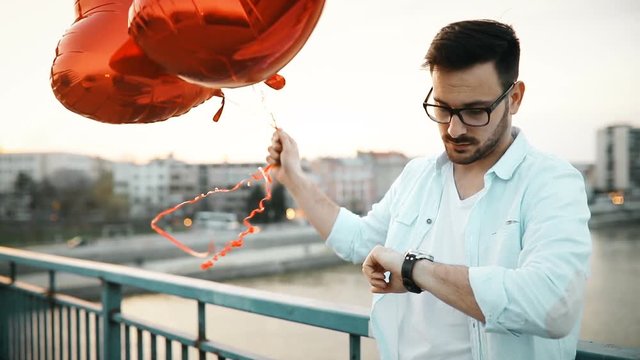 Sad man waiting for date on valentine date