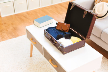 Packing a clothes and accessories in a suitcase for a trip