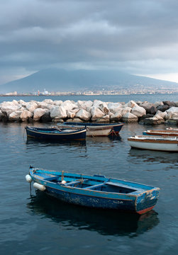 Old boat on the background of a volcano Vesuvius, Naples, Italy