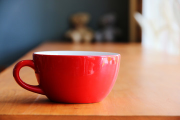 Hot coffee In red cup morning at cafe