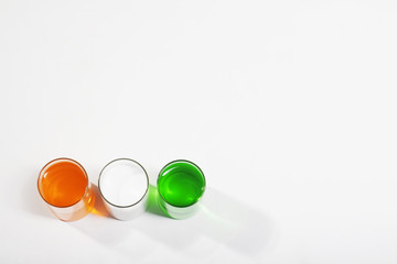 Different coloured paints in a glass 