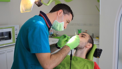 Man sealing his tooth at dental office