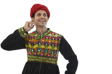 Fototapeta premium Male dandiya dancer listening to music 