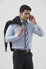 Handsome young businessman talking on cell phone 