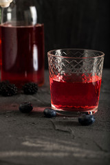 Soda water with blueberry syrup sparkling dark background photo