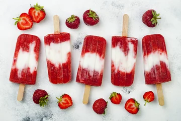 Gordijnen Homemade vegan strawberry coconut milk popsicles - ice pops - paletas on rustic white background © sveta_zarzamora