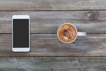 Smart phone and coffee mug on table