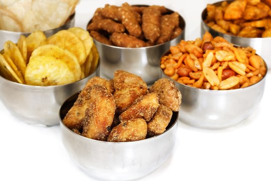 Variety of Indian snacks isolated on white