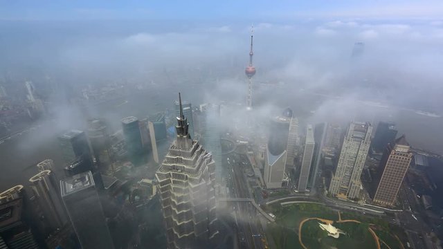 4K: China Shanghai - Aerial view of skyscraper over the sea of ​​clouds.