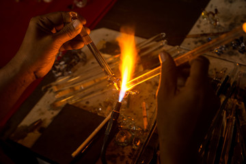 Close up a glass piece melted by a flame