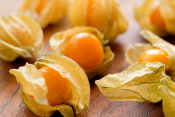 Fresh winter cherries or cape gooseberry on wooden desk